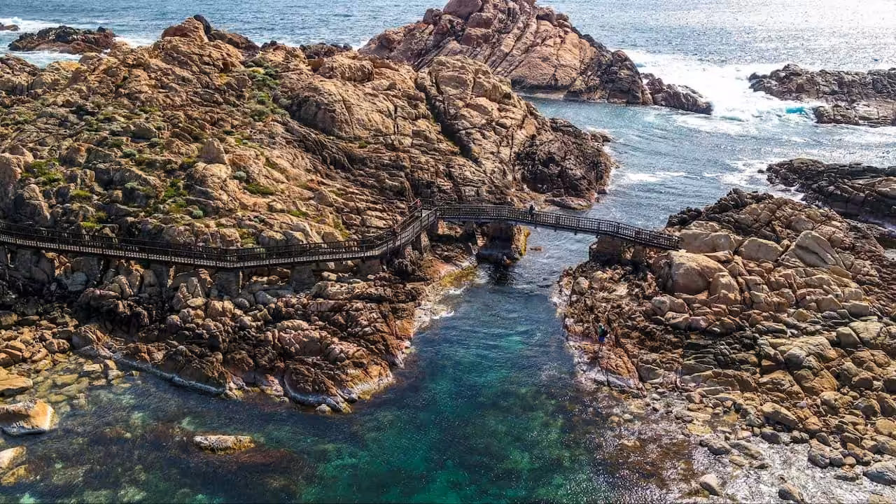 Rocky coastline with wooden bridge in Yallingup, WA