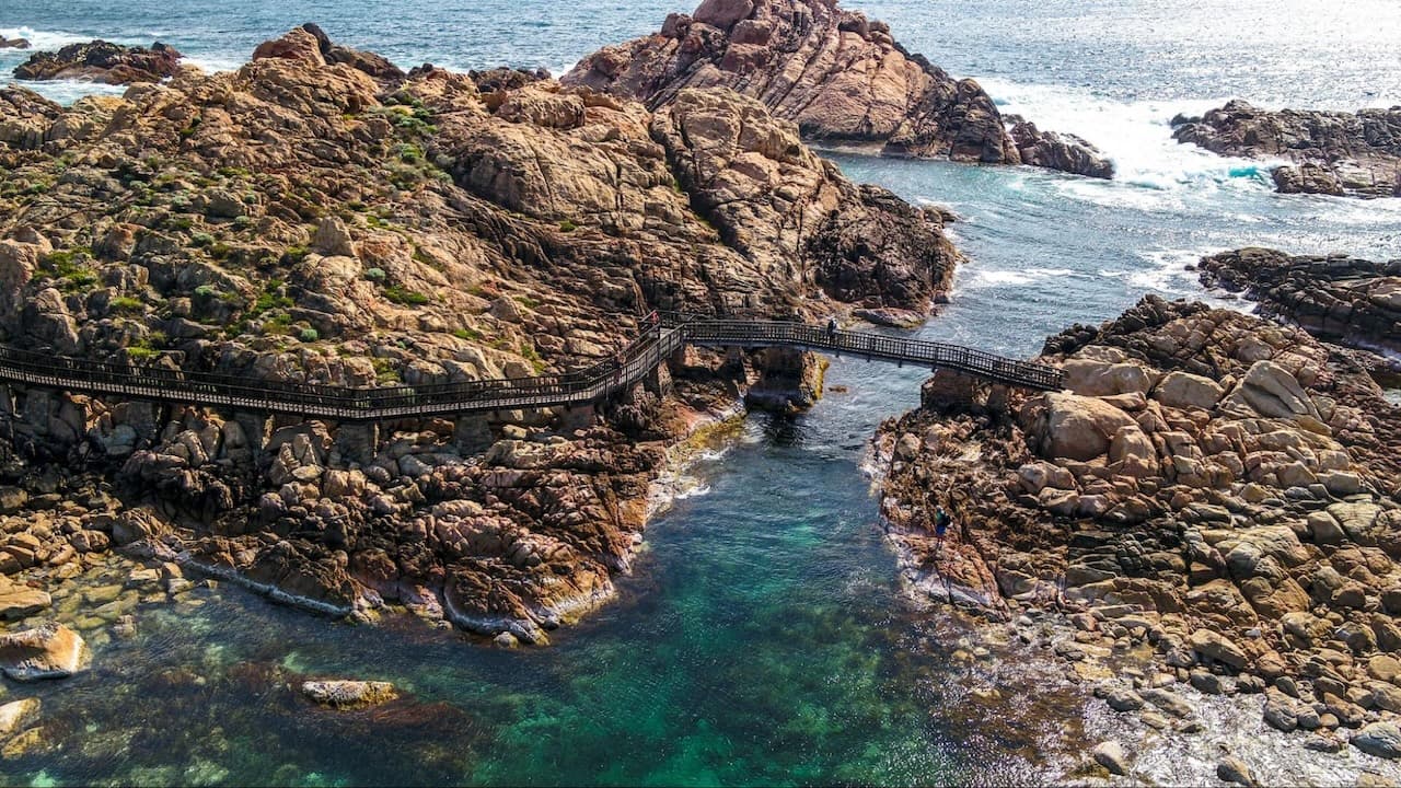 Rocky coastline with wooden bridge in Yallingup, WA